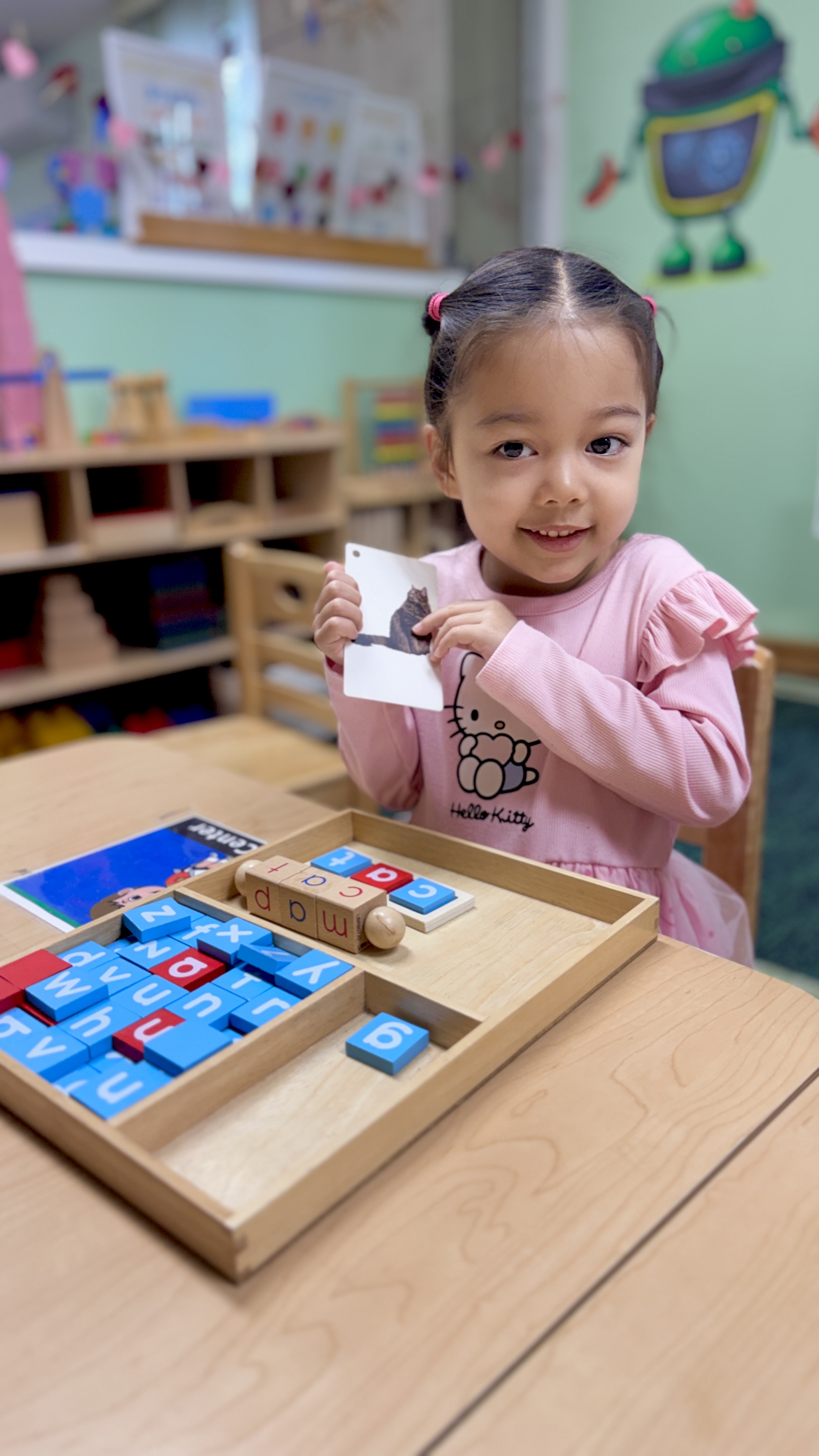 Girl learning with Montessori letter blocks