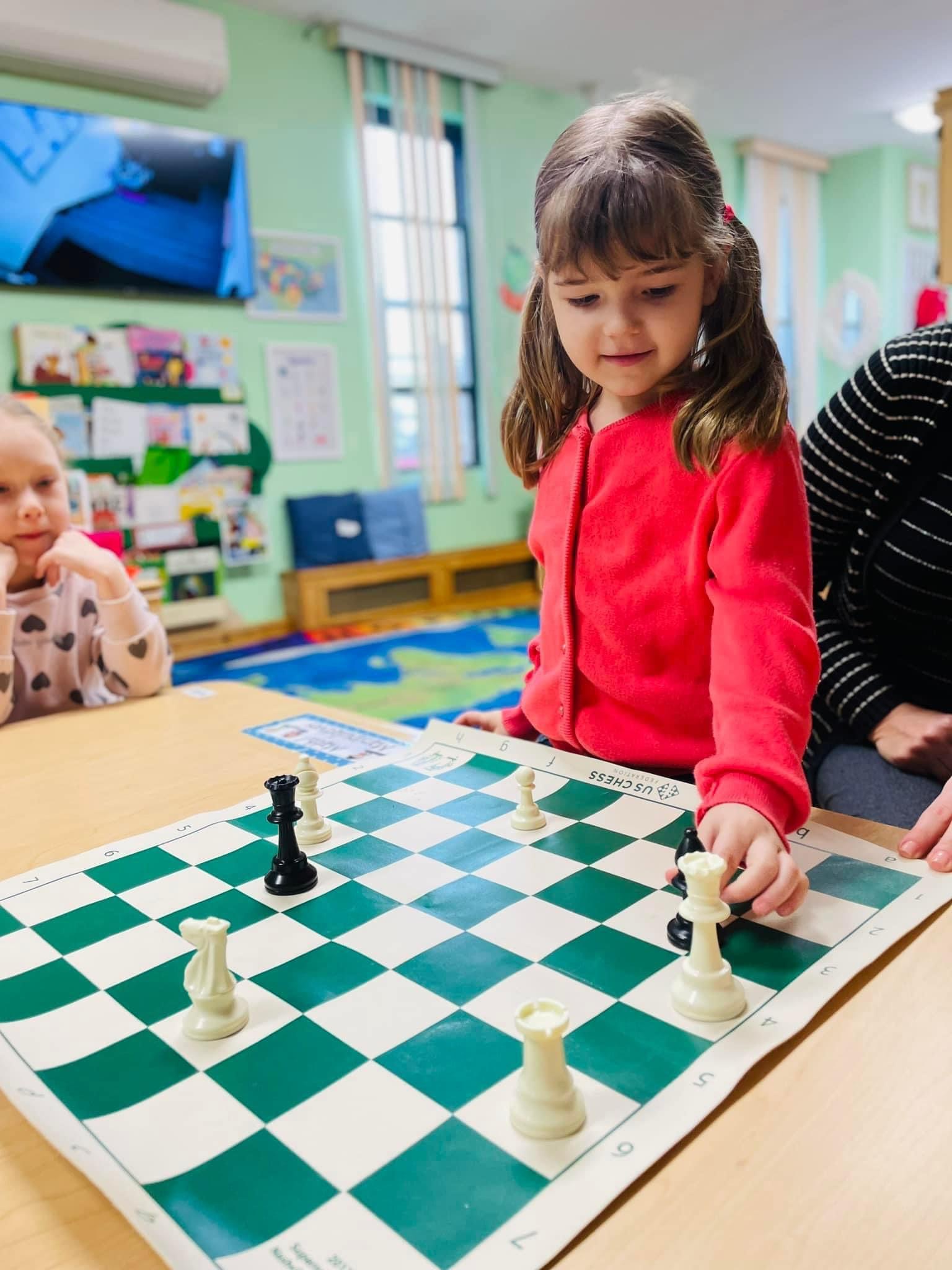 Girl learning chess strategy