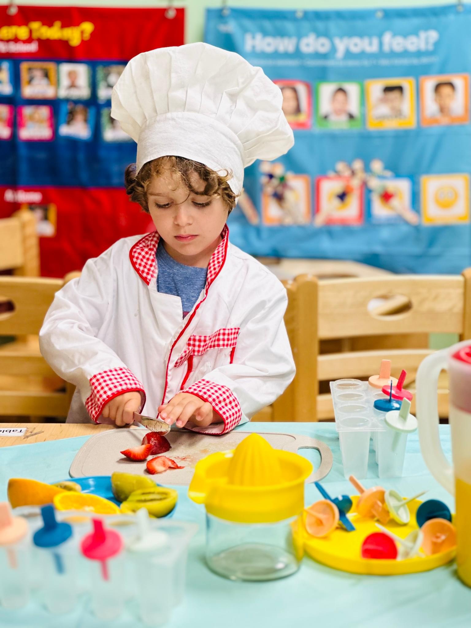 Child in chef hat during cooking class