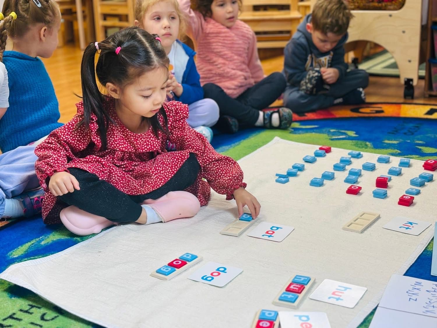 Children building words with letter blocks