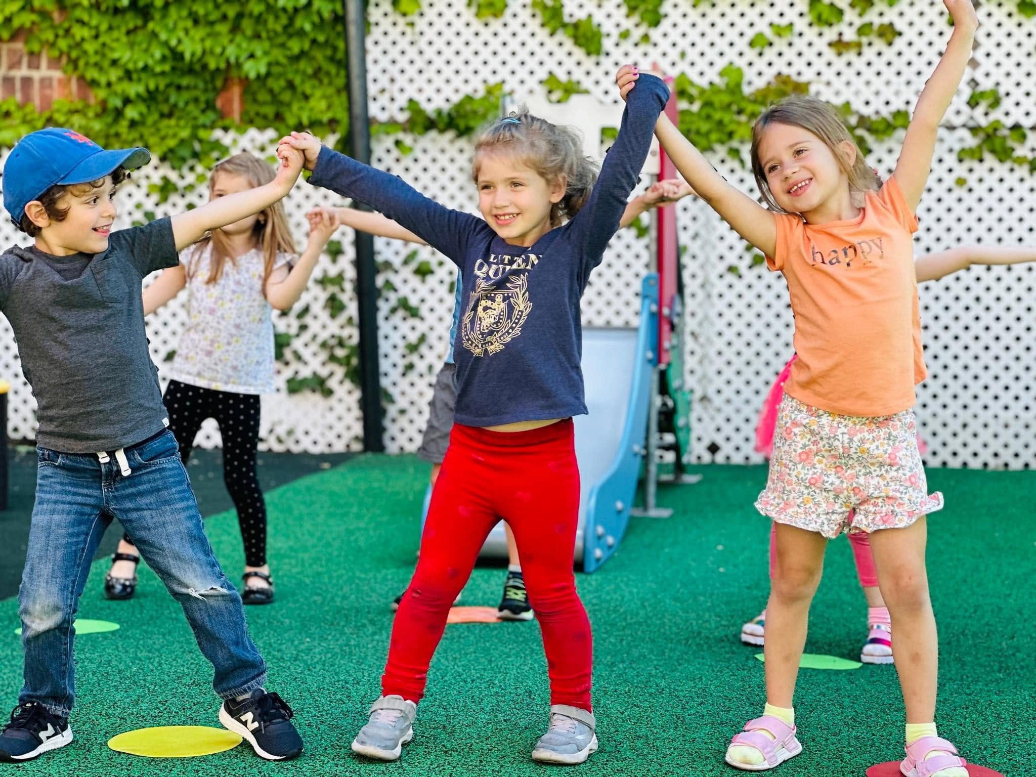 Children dancing together outdoors